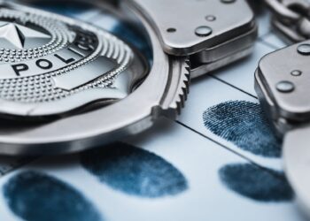 2 found with drugs and guns during parole check in Salina
