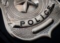 Police say a woman raised a replica revolver at an officer before he shot and killed her early Sunday morning