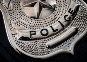 Police say a woman raised a replica revolver at an officer before he shot and killed her early Sunday morning